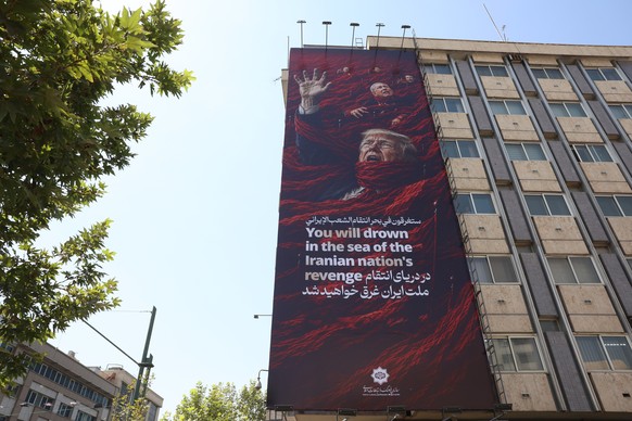 epa13119960 A huge anti-US and Israeli billboard featuring US President Trump and Israeli Prime Minister Netanyahu hangs on a building in Tehran, Iran, 19 July 2026. The conflicts between Iran and the ...
