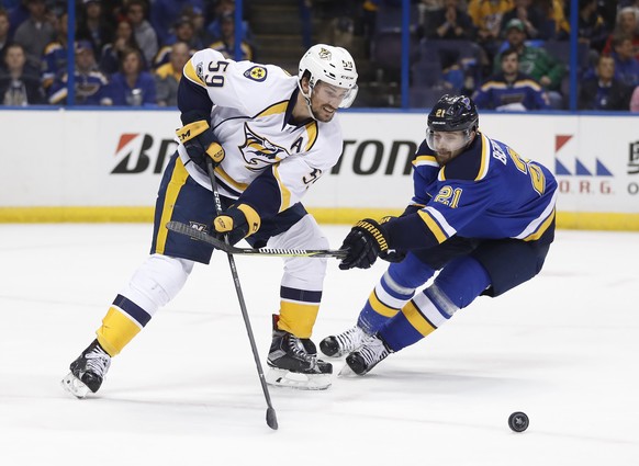 Nashville Predators defenseman Roman Josi (59), of Switzerland, tries to move past St. Louis Blues center Patrik Berglund (21), of Sweden, during the second period in Game 5 of an NHL hockey second-ro ...