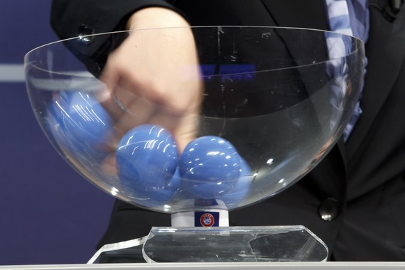 The hand of Nadine Kessler, UEFA Women&#039;s football advisor UEFA, removes the balls containing the names of the soccer national teams, during the drawing of the matches for the 2017-19 European Qua ...