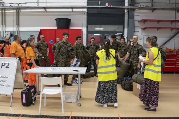 epa13064672 Members of the Swiss Military get briefed prior the departure at the Zurich Airport in Kloten, Switzerland, 25 June 2026. The Rescue Squad, with 80 members, eight search dogs and 18 tonnes ...