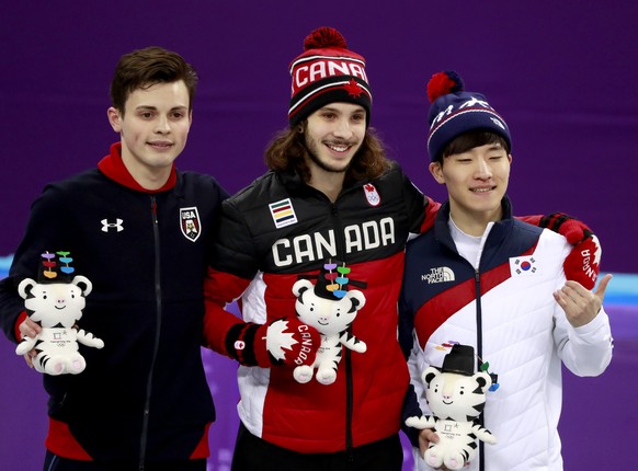 epa06536174 (L-R) Silver medal winner John-Henry Krueger of the USA, Gold medal winner Samuel Girard of Canada and Bronze medal winner Seo Yi-ra of Korea celebrate during the venue ceremony for the Men's Short Track Speed Skating 1000 m final at the Gangneung Ice Arena during the PyeongChang 2018 Olympic Games, South Korea, 17 February 2018.  EPA/HOW HWEE YOUNG