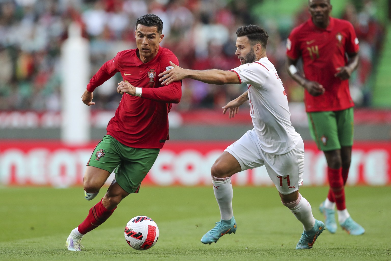 epa09998036 Portugal&#039;s Cristiano Ronaldo (L) in action against Switzerland&#039;s Renato Steffen (R) during the UEFA Nations League soccer match between Portugal and Switzerland in Lisbon, Portug ...