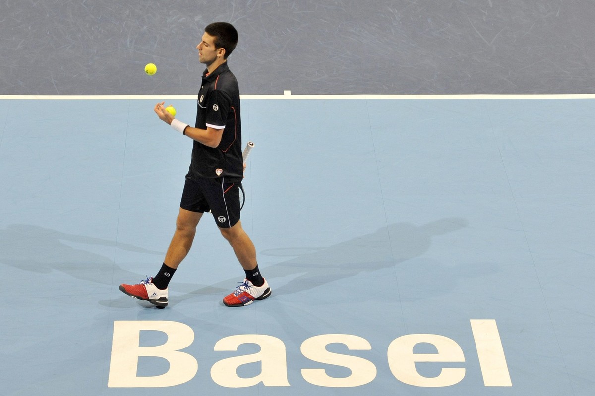 Serbia's Novak Djokovic prepares his serve against Japan's Kei Nishikori during their semifinal match at the Swiss Indoors tennis tournament at the St. Jakobshalle in Basel, Switzerland, Sat ...