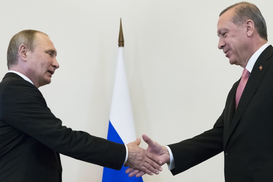 Russian President Vladimir Putin, left, greets Turkish President Recep Tayyip Erdogan in the Konstantin palace outside St.Petersburg, Russia, on Tuesday, Aug. 9, 2016. President Erdogan travels to Rus ...