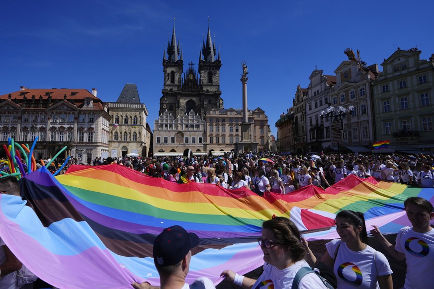People march during the LGBTQ+ parade at the Old Town Square in Prague, Czech Republic, Saturday, Aug. 12, 2023. (AP Photo/Petr David Josek)