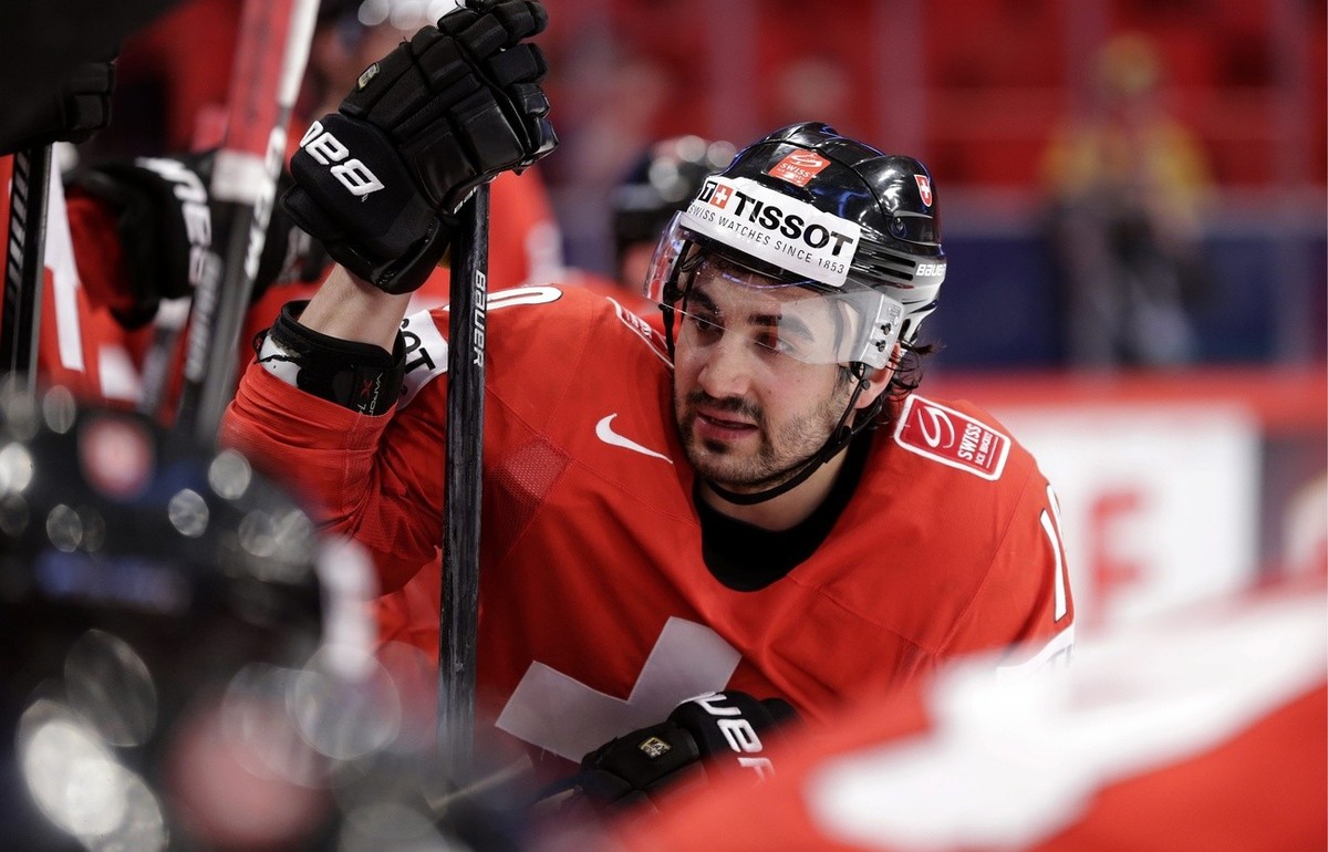 Switzerland's Andres Ambuehl speaks with teammates on the bench, during the IIHF Ice Hockey World Championships preliminary round game Switzerland vs Denmark at the Globe Arena in Stockholm, Swed ...