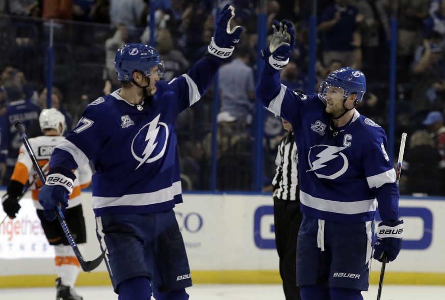 Tampa Bay Lightning center Steven Stamkos, right, celebrates with Victor Hedman after Stamkos scored during a shootout in an NHL hockey game Saturday, March 3, 2018, in Tampa, Fla. The Lightning won t ...