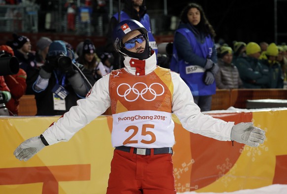 Dimitri Isler, of Switzerland, reacts to his score during the men's aerial final at Phoenix Snow Park at the 2018 Winter Olympics in Pyeongchang, South Korea, Sunday, Feb. 18, 2018. (AP Photo/Kin Cheung)