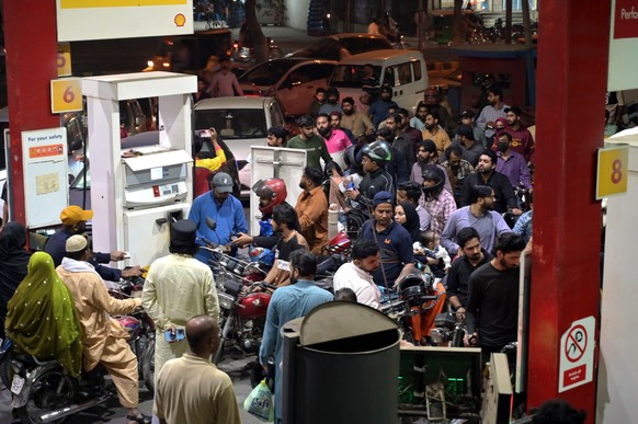 epa12800200 People queue to fill their vehicles at a fuel station amid concerns over a potential petroleum shortage in Lahore, Pakistan, 07 March 2026. Pakistan increased fuel prices by 55 Pakistani r ...