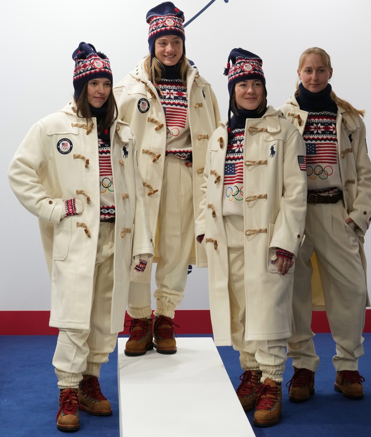 From left, United States' Tess Johnson, Olivia Giaccio, Jaelin Kauf and Elizabeth Lemley pose for a photographer as they wear the Team USA uniforms designed by Ralph Lauren, at the 2026 Winter Ol ...