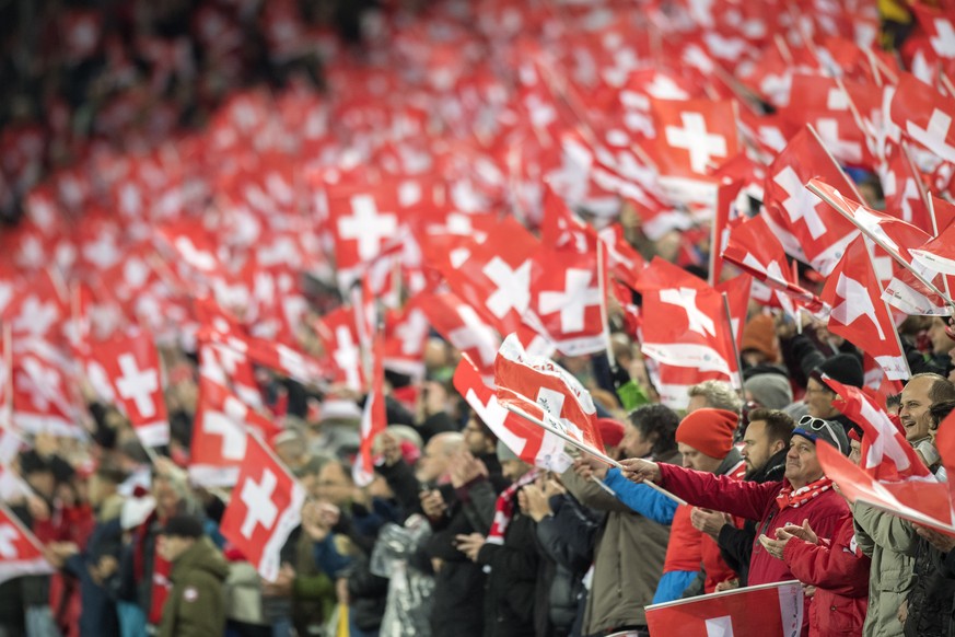 SwitzerlandÕs supporters with the Swiss flags cheer their team, prior the 2018 Fifa World Cup play-offs second leg soccer match Switzerland against Northern Ireland at the St. Jakob-Park stadium in Ba ...