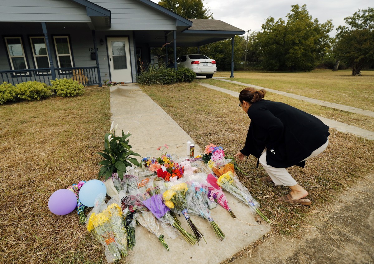 Anastasia Gonzalez, of Burleson, Texas, leaves a flowers on the front sidewalk of Atatiana Jefferson's home on E. Allen Ave in Fort Worth, Texas, Tuesday, Oct. 15, 2019. Jefferson, a black woman, ...