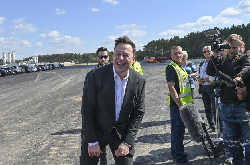 Technology entrepreneur Elon Musk laughs as he visits the Tesla Gigafactory construction site in Gruenheide near Berlin, Germany, Sept. 3, 2020. (Patrick Pleul/dpa via AP)