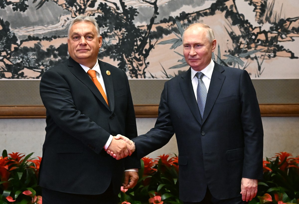 epa10923359 Hungarian Prime Minister Viktor Orban (L) and Russian President Vladimir Putin shake hands before their meeting as part of the 3rd Belt and Road Forum at the Diaoyutai State Guest House in ...