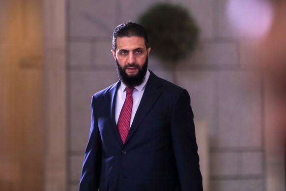 epa12039176 Syrian interim President Ahmed al-Sharaa walks out to welcome Palestinian Authority President Mahmoud Abbas (not pictured) in Damascus, Syria, 18 April 2025. Abbas&#039;s arrival in Damasc ...
