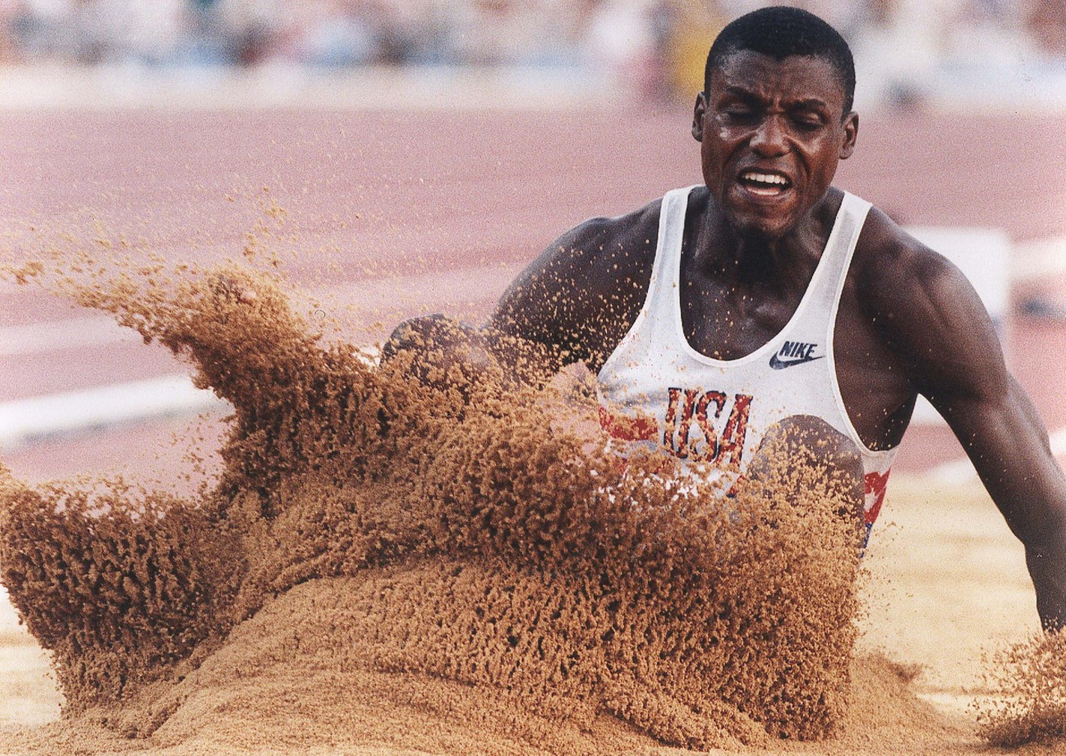 USA's Carl Lewis hits the sand on his fifth jump during the long jump competition at the Summer Olympics in Barcelona Thursday, Aug. 6, 1992. Lewis won the gold medal in the event. (AP Photo/Eric Risb ...