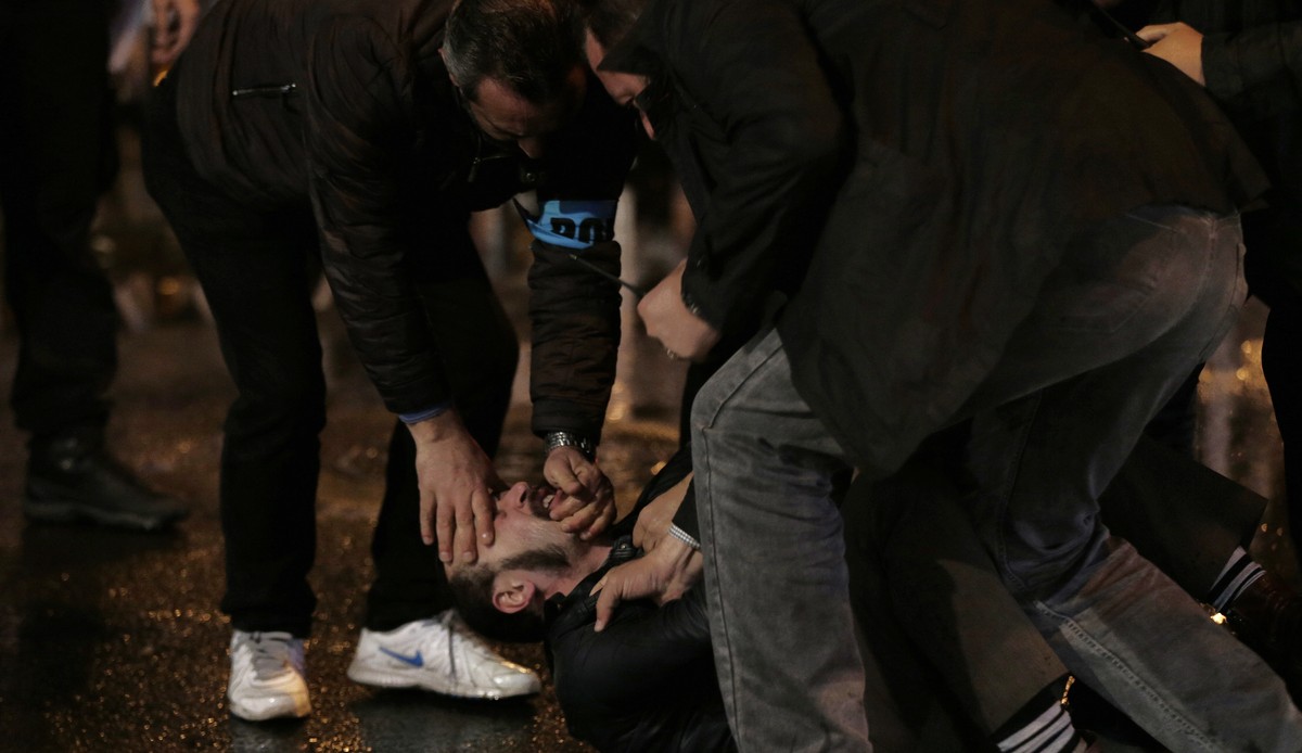 Riot police officers detain a protester outside the Supreme Electoral Board in Ankara, Turkey, late Sunday, April 16, 2017. Turkey's main opposition Republican People's Party leader Kemal Ki ...