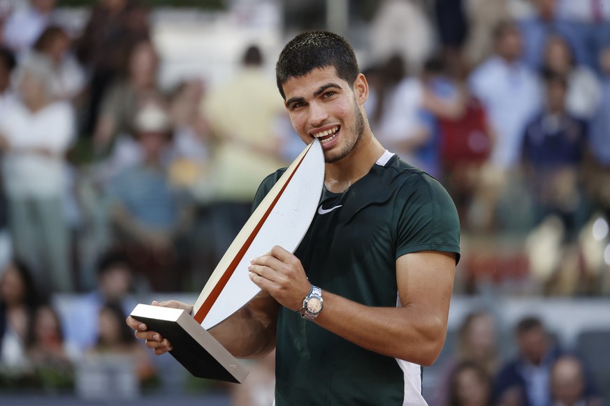 epa09934405 Carlos Alcaraz of Spain celebrates with his trophy after defeating Alexander Zverev of Germany following their Mutua Madrid Open tennis tournament&#039;s final match at Caja Magica sport c ...