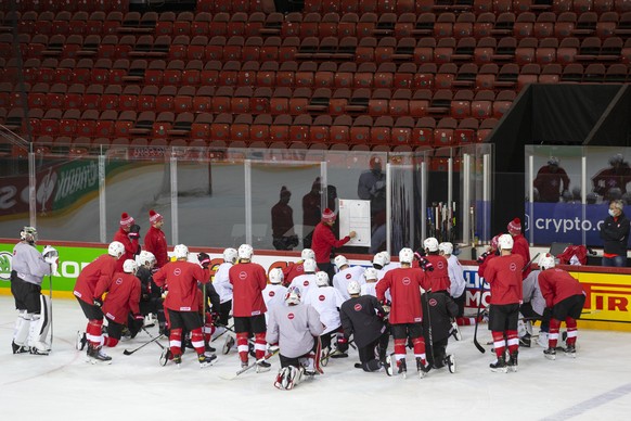 Patrick Fischer, head coach of Switzerland national ice hockey team, instructs his players during a training session, at the IIHF 2021 World Championship quarter final game between Switzerland and Ger ...