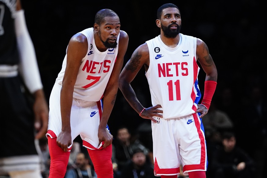 Brooklyn Nets&#039; Kevin Durant (7) talks to Kyrie Irving (11) during the second half of an NBA basketball game against the San Antonio Spurs, Monday, Jan. 2, 2023, in New York. The Nets won 139-103. ...