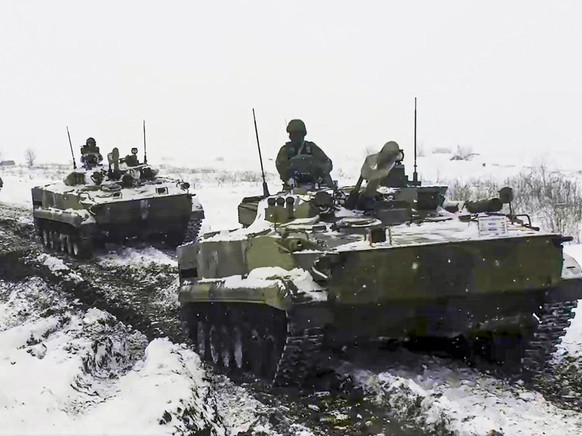 FILE - In this photo provided by the Russian Defense Ministry Press Service on Wednesday, Jan. 26, 2022, a Russian military vehicles moves during a military exercising at a training ground in Rostov r ...