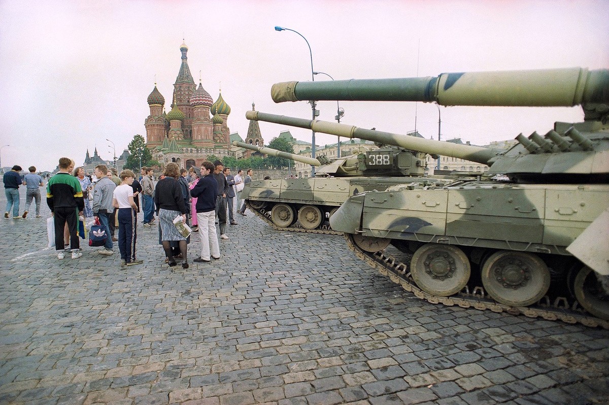 FILE - In this Monday, Aug. 19, 1991 file photo, Groups of people wander among the half dozen Soviet tanks parked behind the Red Square with St. Basil's Cathedral in the background, near the bank ...