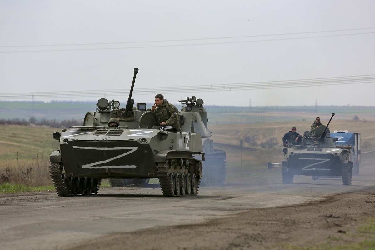 Russian military vehicles move on a highway in an area controlled by Russian-backed separatist forces near Mariupol, Ukraine, Monday, April 18, 2022. Mariupol, a strategic port on the Sea of Azov, has ...