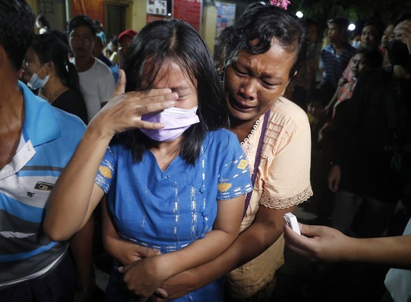 epa09530198 A released woman (L) reacts as she meets with her mother outside the Insein prison in Yangon, Myanmar, 18 October 2021. Myanmar&#039;s junta chief Min Aung Haling announced the released of ...