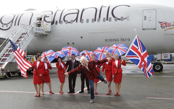 Richard Branson, center, founder of Virgin Atlantic and the Virgin Group, poses for a photo after he arrived on a flight from London to Seattle, Monday, March 27, 2017, at Seattle-Tacoma International ...