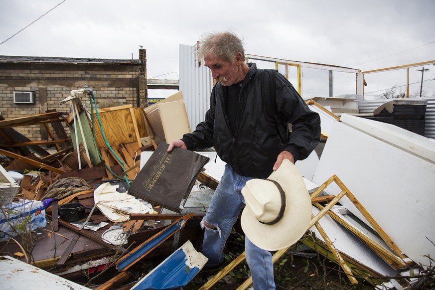 In this Aug. 26, 2017 photo, Harold Nubles searches through what is left of his barbecue truck in Refugio, Texas, that was destroyed by Hurricane Harvey. (Olivia Vanni/The Victoria Advocate via AP)