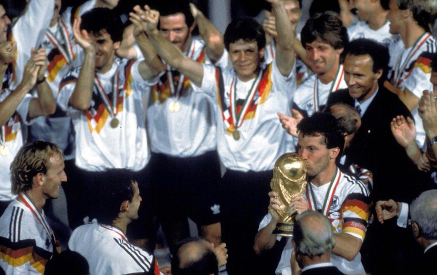 German soccer team players celebrate after winning the Soccer World Cup final in the Olympic Stadium, in Rome, Italy, on July 8, 1990. Germany defeated Argentina 1-0 to win the cup. Player kissing the ...