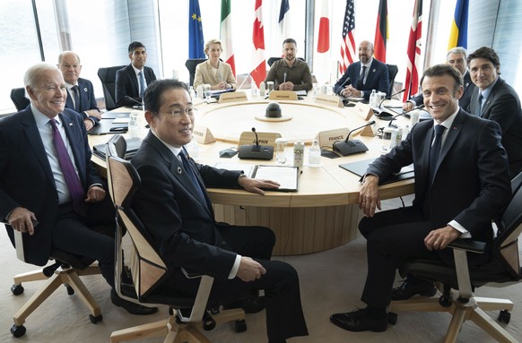 Ukrainian President Volodymyr Zelenskyy, center rear, joins G7 world leaders at a working session on the final day of the G7 Summit in Hiroshima, Japan, Sunday, May 21, 2023. From left to right are: J ...