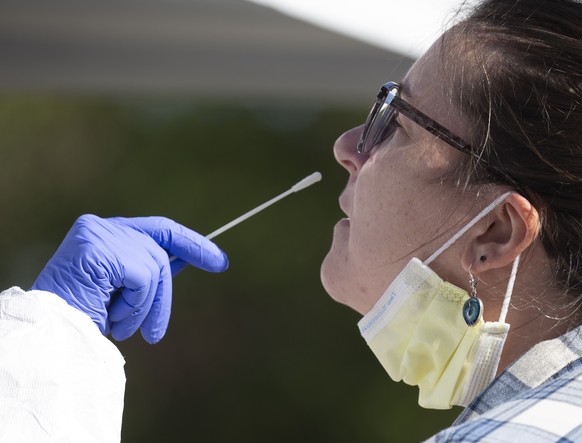 epa08748972 Caitlin Surprise of Jamaica Plain takes a Coronavirus test at a pop up testing center in Boston, Massachusetts, USA, 15 October 2020. The recent rise in cases has prompted Boston&#039;s Ma ...