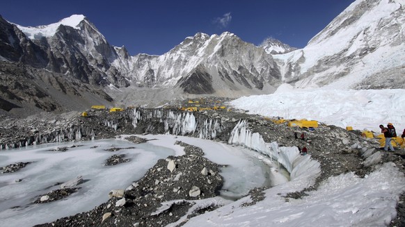 FILE - Tents are set up for climbers on the Khumbu Glacier, with Mount Khumbutse, center, and Khumbu Icefall, right, seen in background, at Everest Base Camp in Nepal on April 11, 2015. As glaciers me ...