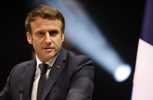 French President Emmanuel Macron delivers his speech during a tribute ceremony for victims of the 2012 attacks, at the Halle aux Grains in Toulouse, southwestern France, Sunday, March 20, 2022. French ...