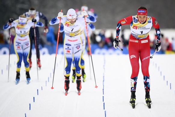 The winner Kristine Stavaas Skistad of Norway, right, crosses the finish line ahead of second placed Emma Ribom of Sweden, center, and thirs placed Maja Dahlqvist of Sweden, right, during the Women's  ...