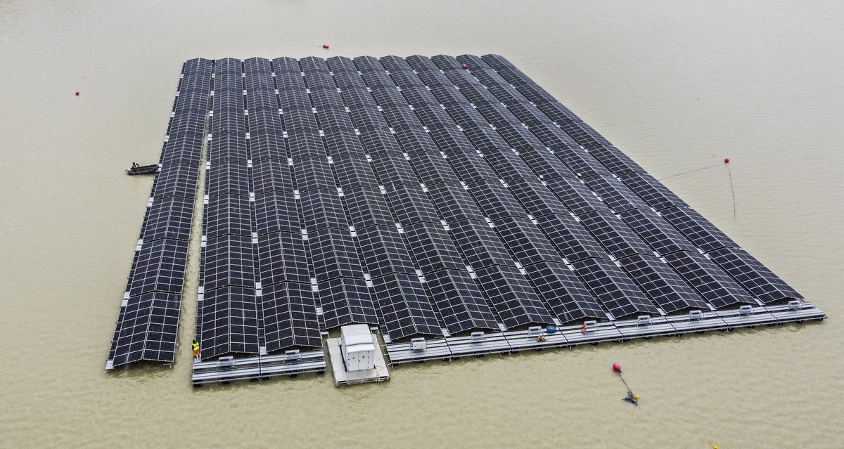 Solar panels are pulled by a boat to a floating photovoltaic plant on a lake in Haltern, Germany, Friday, April 1, 2022. Once completed, around 5,800 photovoltaic modules will produce around 3 million ...