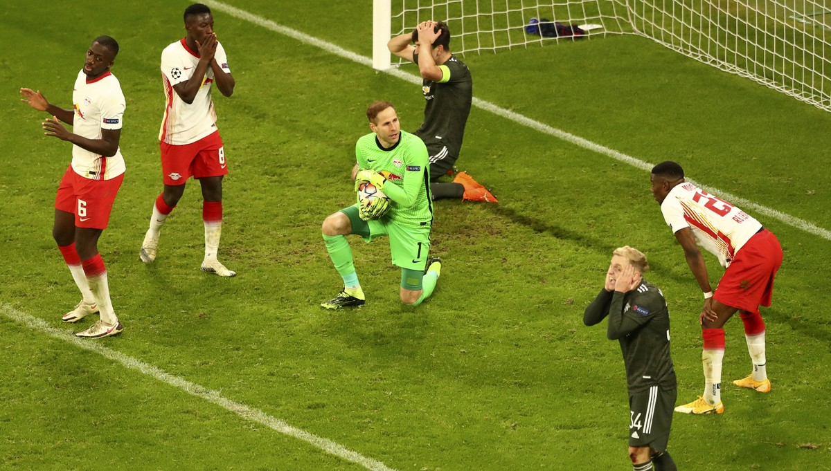 Manchester United's Donny van der Beek, foreground right, and team mate Harry Maguire, background top, react as Leipzig's goalkeeper Peter Gulacsi saves the ball during the Champions League  ...