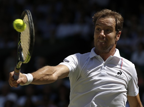 Richard Gasquet of France returns a shot to Novak Djokovic of Serbia during the men&#039;s singles semifinal match at the All England Lawn Tennis Championships in Wimbledon, London, Friday July 10, 20 ...