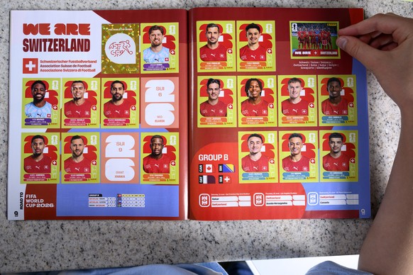 A young collector sticks a Panini World Cup sticker of the Switzerland's soccer national team in the official panini album of the 2026 FIFA World Cup USA Canada Mexico, in Lausanne, Switzerland,  ...