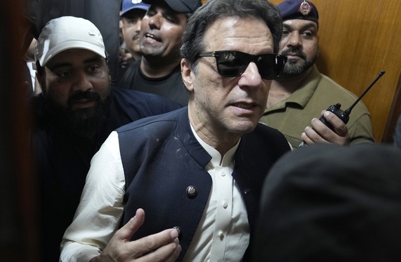 Former Pakistani Prime Minister Imran Khan, center, leaves court after a performance in Lahore, Pakistan, Friday, May 19, 2023. Khan ended his resistance campaign on Friday, saying he would use all…