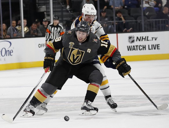 Vegas Golden Knights left wing James Neal and Buffalo Sabres center Jack Eichel (15) battle for the puck during overtime of an NHL hockey game Tuesday, Oct. 17, 2017, in Las Vegas. The Golden Knights  ...