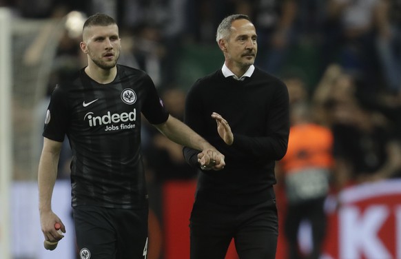 Frankfurt's Ante Rebic, left, celebrates with Frankfurt's coach Adolf Huetter at the end of the Europa League quarterfinals, second leg soccer match between Eintracht Frankfurt and Benfica at the Comm ...