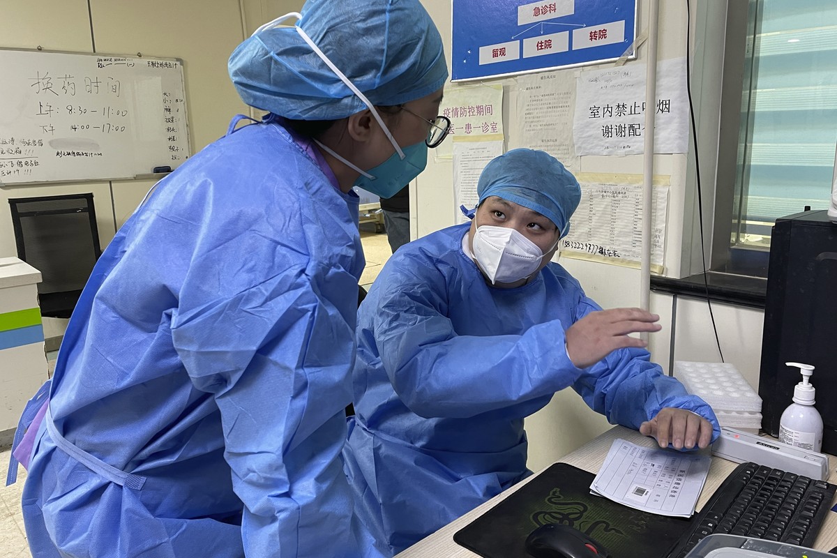 Hospital workers discuss their work at the emergency department of Baigou New Area Aerospace Hospital in Baigou, in northern China's Hebei province on Thursday, Dec. 22, 2022. As China grapples w ...