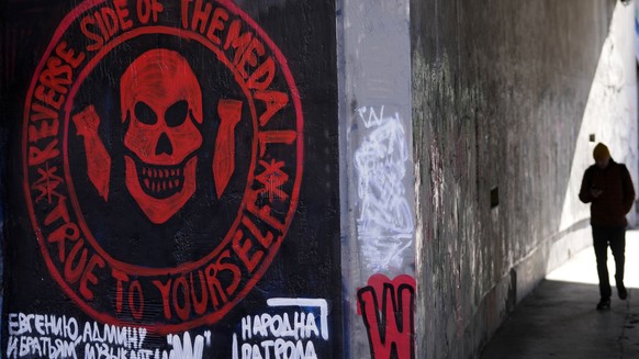 A man walks by a drawn again mural depicting the logo of Russia&#039;s Wagner Group on a wall in Belgrade, Serbia, Thursday, Jan. 19, 2023. A friendly, fellow-Slavic nation, Serbia has welcomed the fl ...