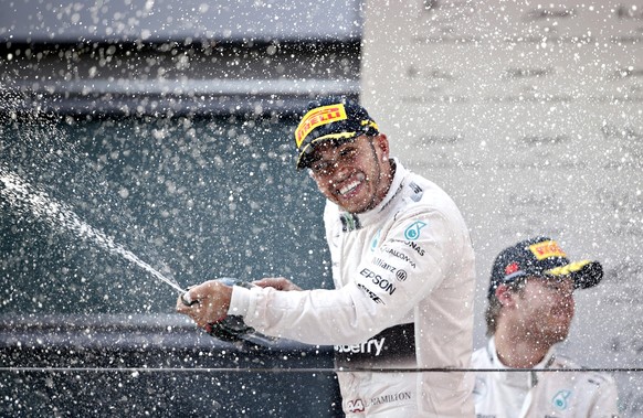 Mercedes Formula One driver Lewis Hamilton of Britain sprays champagne as he celebrates his victory on the podium after the Chinese F1 Grand Prix at the Shanghai International Circuit, April 12, 2015. ...