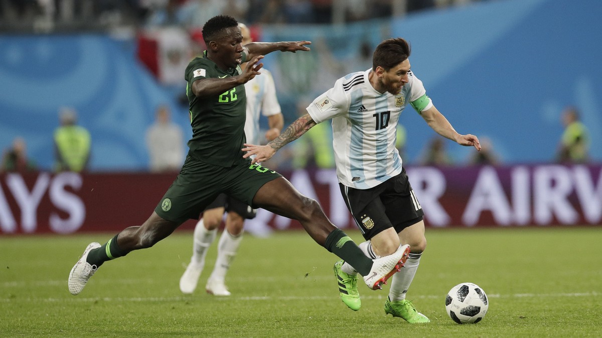 Argentina's Lionel Messi, right, and Nigeria's Kenneth Omeruo, left, compete for the ball during the group D match between Argentina and Nigeria at the 2018 soccer World Cup in the St. Peter ...