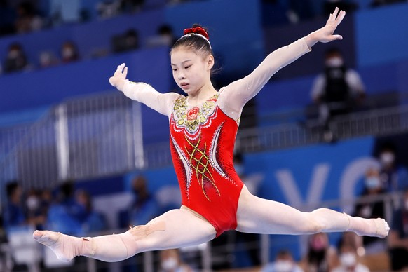 epa09390544 Chenchen Guan of China competes in the Women&#039;s Balance Beam Final during the Artistic Gymnastics events of the Tokyo 2020 Olympic Games at the Ariake Gymnastics Centre in Tokyo, Japan ...