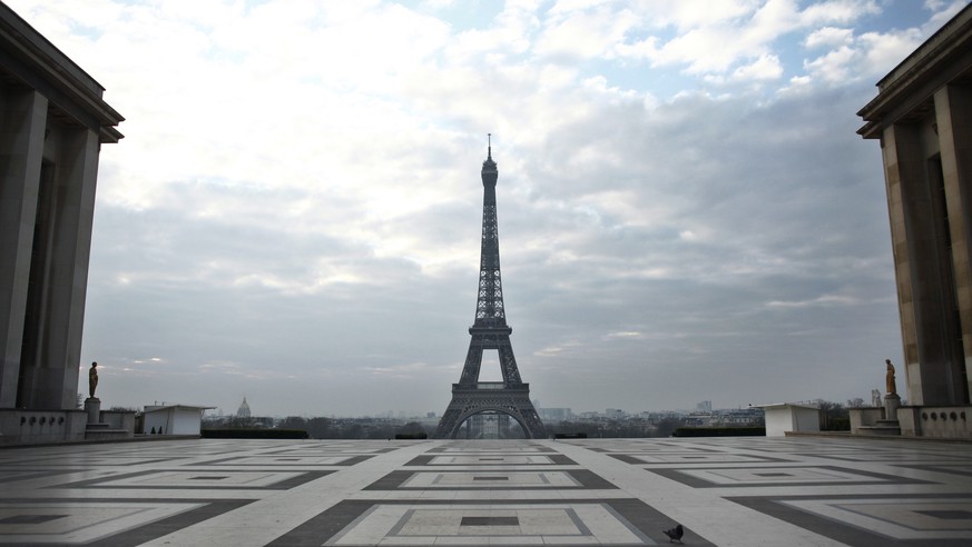 Pigeons walk on the Trocadero square in front of the Eiffel Tower, in Paris, March 18, 2020. (AP Photo/Thibault Camus)
