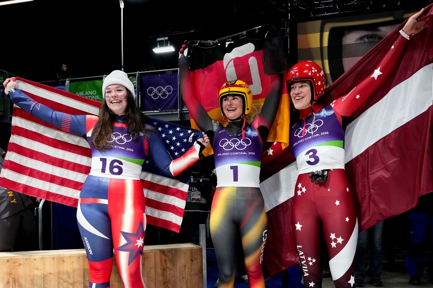 From left, United States' bronze medlist Ashley Farquharson, Germany's gold medalist Julia Taubitz and Latvia's siler medalist Elina Bote celebrate after the women's single luge co ...